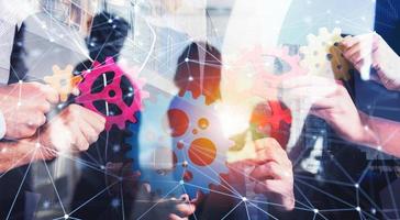Business team connect pieces of gears. Teamwork, partnership and integration concept with network effect. double exposure photo