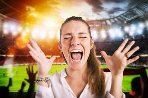 Football scene at night match with cheering fans at the stadium photo