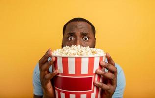 Worried boy watches a horror film. concept of entertainment and streaming tv. background photo