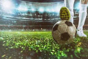 Close up of a soccer striker ready to kicks the ball at the stadium photo