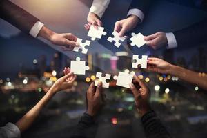 Teamwork of partners. Concept of integration and startup with puzzle pieces. Double exposure photo