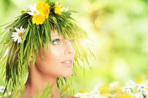 Mother nature beauty concept with girl hair made of flowers and grass. photo