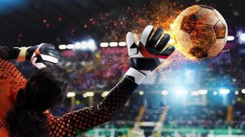 Goalkeeper catches the fireball in the stadium during a football game. photo