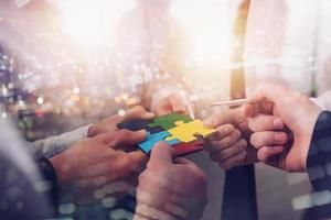 Teamwork of partners. Concept of integration and startup with puzzle pieces photo
