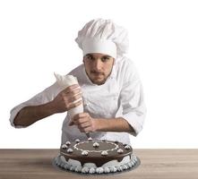 Pastry cook prepares a cake photo