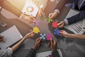 Teamwork of partners. Concept of integration and startup with puzzle pieces photo