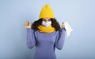 Girl with mask caught a cold. Violet background photo