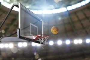 Basketball scene of a ball that is entering the basket photo