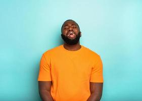 Afro man with unhappy expression is crying photo