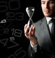 Businessman holding a hourglass photo