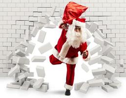 Santa Claus enters to deliver the gift by making a hole in the wall photo