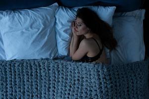 Girl sleeps in a cozy bed during the night. Concept of relax and rest photo