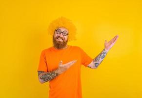 Happy man with beard, yellow wig and glasses photo