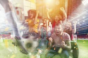 Happy friends of football fans watching soccer on tv and celebrating victory with falling confetti. Double exposure photo