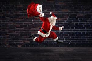 santa claus runs fast to deliver all gifts for christmas photo