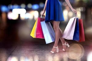 Woman with shopping bags in hand walks in the city photo