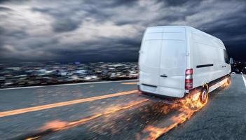 Super fast delivery of package service with van with wheels on fire. photo