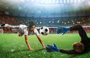 Goalkeeper catches the ball in the stadium during a football game. photo