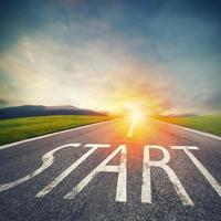 Start written to the ground on a road at sunset. Concept of new beginning and starting new opportunities photo