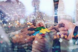 Teamwork of partners. Concept of integration and startup with puzzle pieces photo