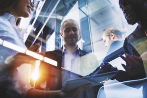 Business people connected on internet network with a tablet. concept of startup company. Double exposure photo