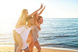 Happy smiling couples playing at the beach photo