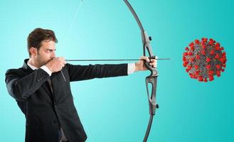 Man want to destroy the covid-19 coronavirus with bow and arrow photo