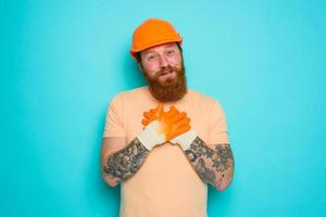 Worker with yellow hat is happy about his work photo