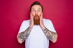 amazed isolated man with beard and white t-shirt photo