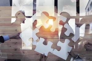 Business people work together to build a puzzle. Concept of teamwork, partnership, integration and startup. double exposure photo