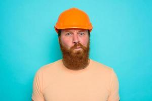 Worker with yellow hat is confused about his work photo