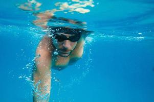 Sporty man swims fast in the sea photo