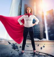 Businesswoman acts like a super hero. Concept of success and determination photo