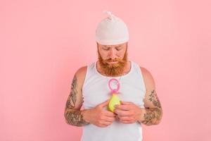 Delusion man with beard and tattoos acts like a small newborn photo