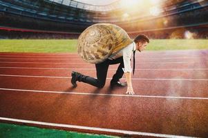 Businessman runs slow like a snail in a runner race photo