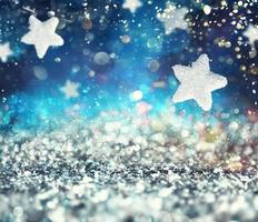 Abstract glowing Christmas blue background with stars photo