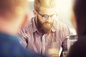 Businessman works with a tablet during a meeting photo