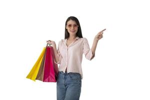 Happy woman with shopping bags in hand indicates something photo