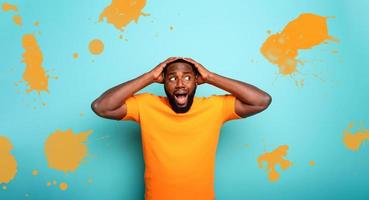 Amazed and shocked expression of a boy over cyan background photo