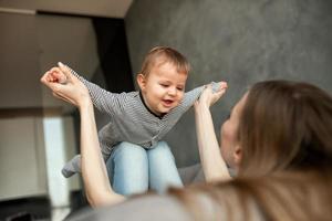 Little child smiling and happy with mom photo