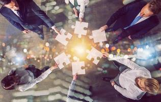 Teamwork of partners. Concept of integration and startup with puzzle pieces photo