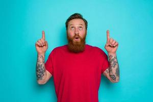 Man is wondered and indicates something with hand photo