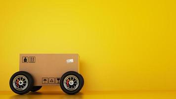 Cardboard box with racing wheels like a car on a yellow background. Fast shipping by road photo