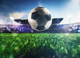 Close up of a soccer ball kicked with power at the stadium photo