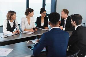 Team of businessmen work together in office. Concept of teamwork and partnership photo