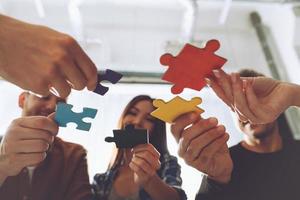 Teamwork of partners. Concept of integration and startup with puzzle pieces photo
