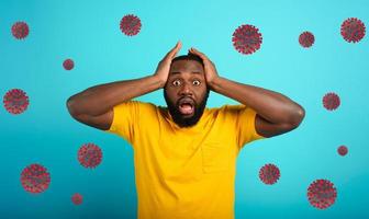 Fearful expression of a boy who is scared to catch the coronavirus. Cyan background. photo
