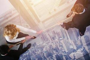 Group of business competitors pull a rope as a challenge photo