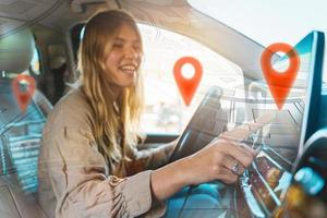 Woman selects the destination with car gps navigator photo