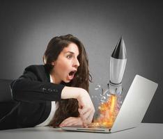 Businesswoman launches rocket from a laptop. concept of company startup photo